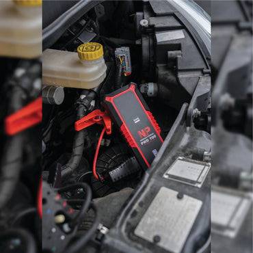 GYS Nomad Power 700 028838 2000A Lithium Jump Pack connected to a car battery, showcasing its compact design and powerful jump-starting capability.