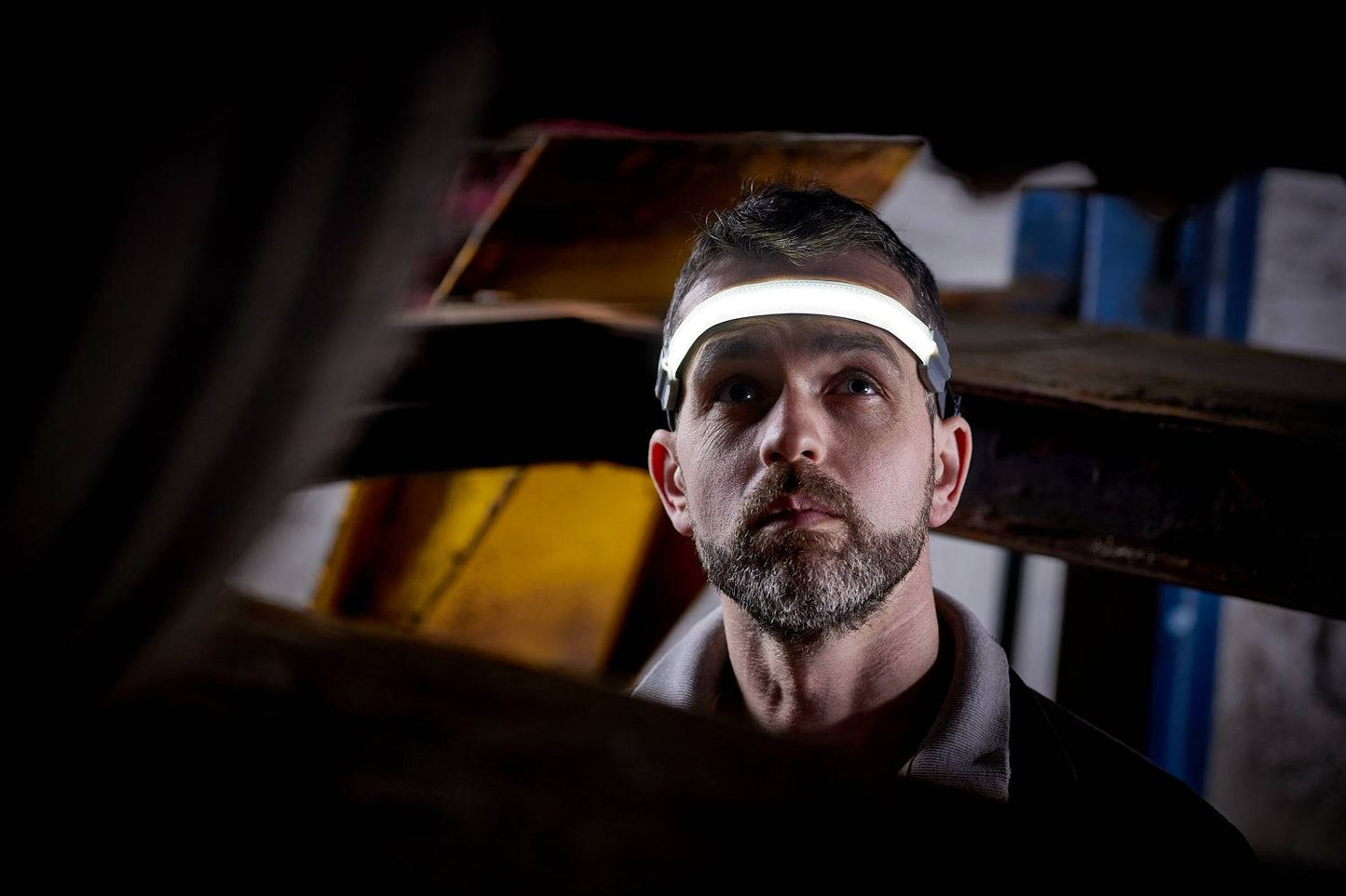 Flexible Head Torch RIL0115 in dim workspace, demonstrating hands-free lighting with wide beam for effective visibility.