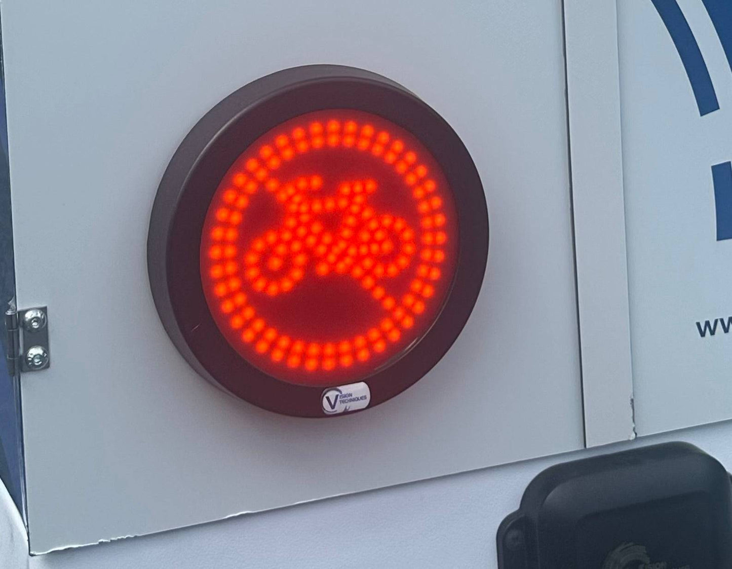 VT LED Cyclists Warning Turn Sign mounted on a vehicle, displaying a bright red illuminated bicycle symbol to alert nearby cyclists during turns.