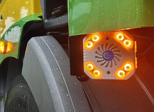 Vision Techniques - VT Turnalarm Visual and Audible Warning System mounted on a truck, emitting bright amber LED lights to alert road users during turns.